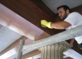 Cleaning the wood ceiling beams.