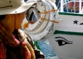 Regular Member Rachel McCleery prepares to photograph an eye on the adjacent boat.