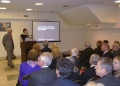 Ambassador Aghi Balta welcomes guests to the lecture at the Consulate