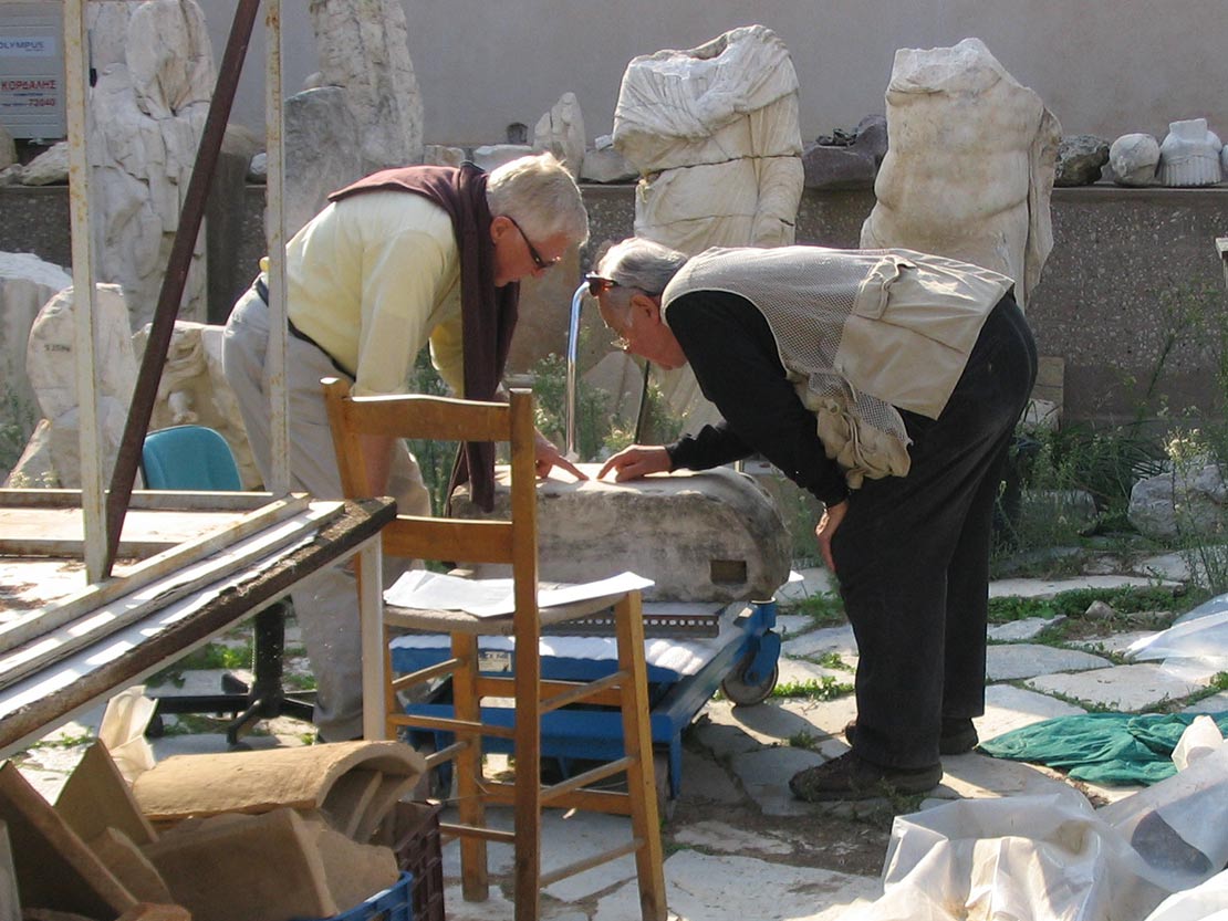 Ron Stroud and James Wiseman study an inscribed Herm.