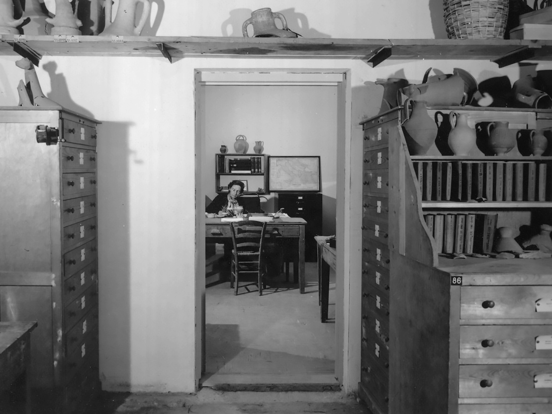 Virginia Grace in the ‘Wine Jars Workrooms’ of the Stoa of Attalos in 1957. The cases in the foreground, all custom-made to Grace’s plans and specifications, hold stamped amphora handles and are still in use today.