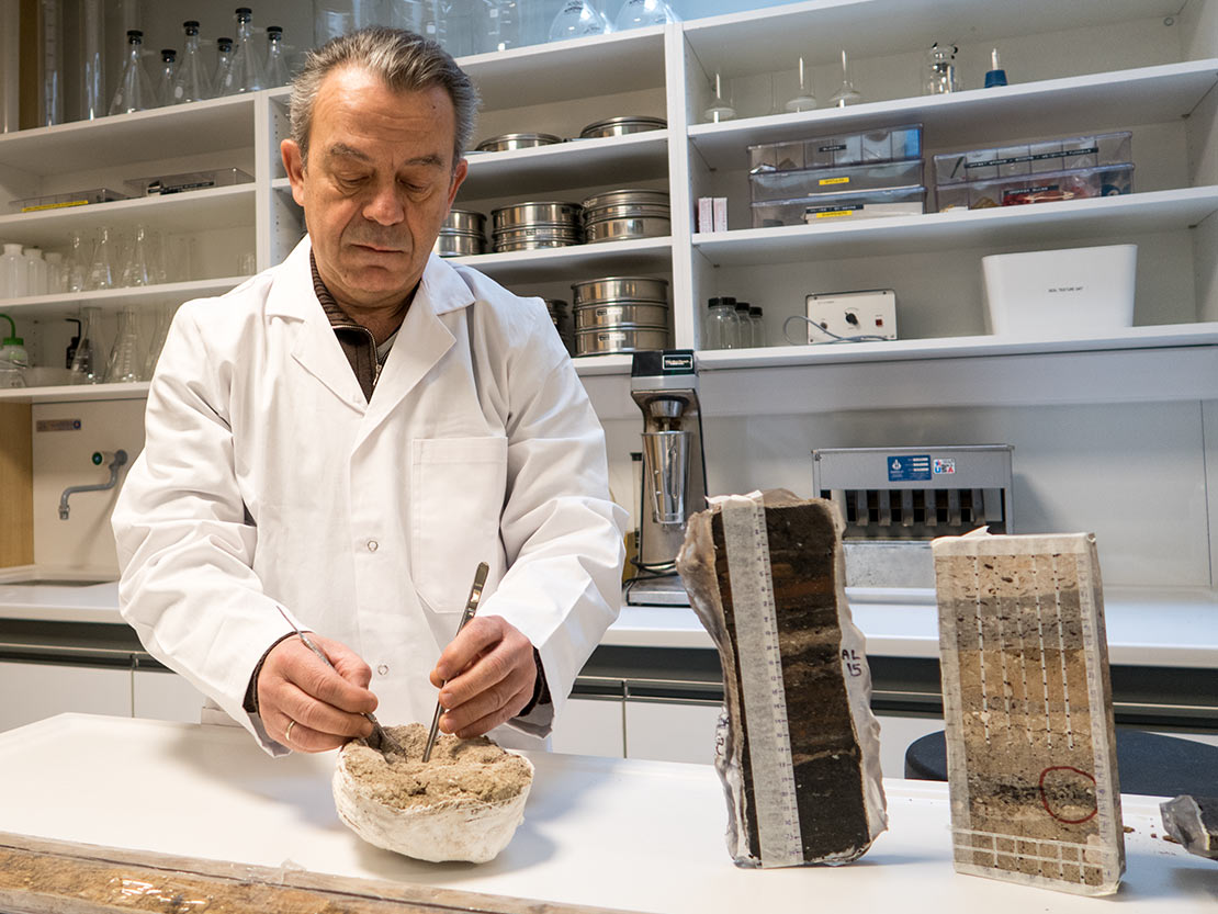 Director Takis Karkanas examines archaeological soil in the Wiener Lab